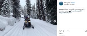 two people riding a snowmobile