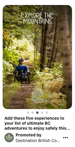 Woman in all-terrain wheelchair on a forest trail, as she explores the mountains.