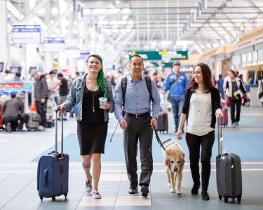 Steven Woo, employee of Vancouver Airport Authority, walking with friends and his assistance dog, Horatio.