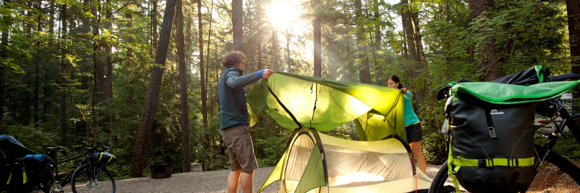 Couple setting up their tent at a campsite in Nairn Falls Provincial Park.