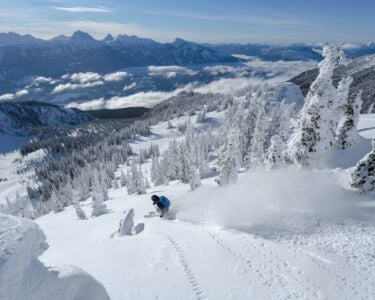 Skier riding down a side-country trail at Mount Mackenzie, Revelstoke.